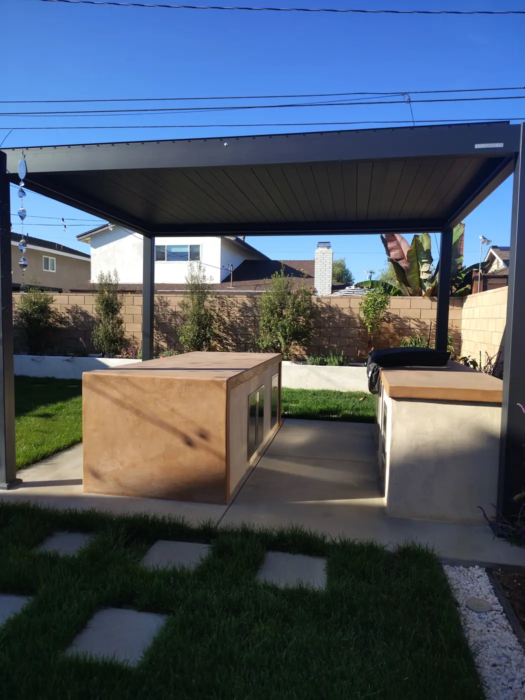 Modern louvered pergola and outdoor kitchen built by Westerfield Landscapes